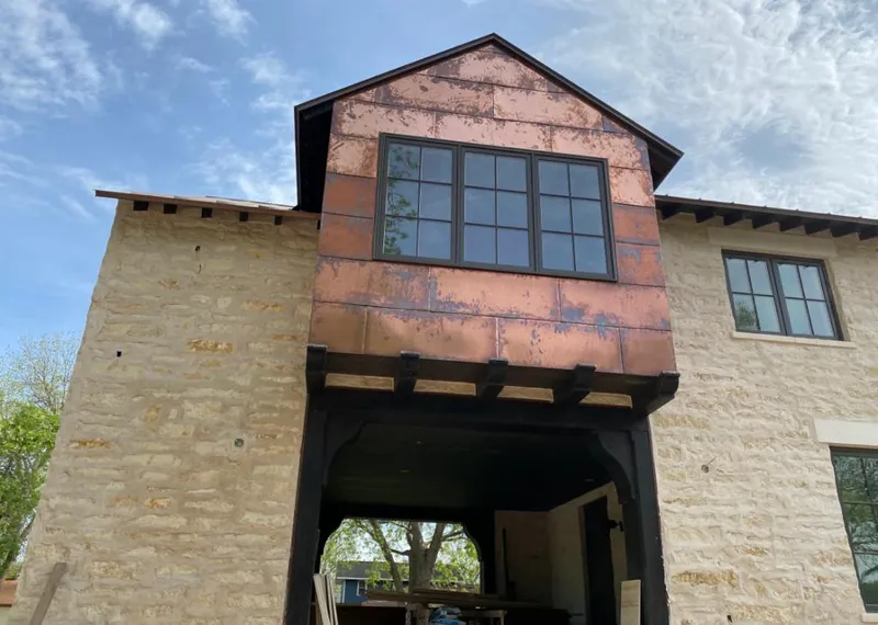 Copper metal panel facade on a stone building for Skylight Installation in Chesapeake