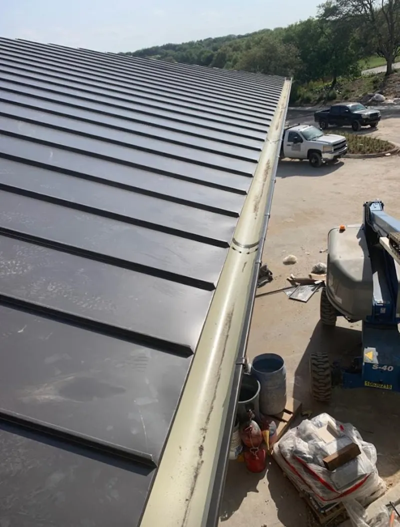 Standing seam panel and gutter detail on a metal roofing jobsite in Chesapeake